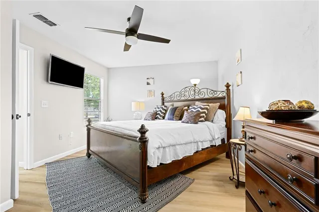 a bedroom with a bed and a ceiling fan