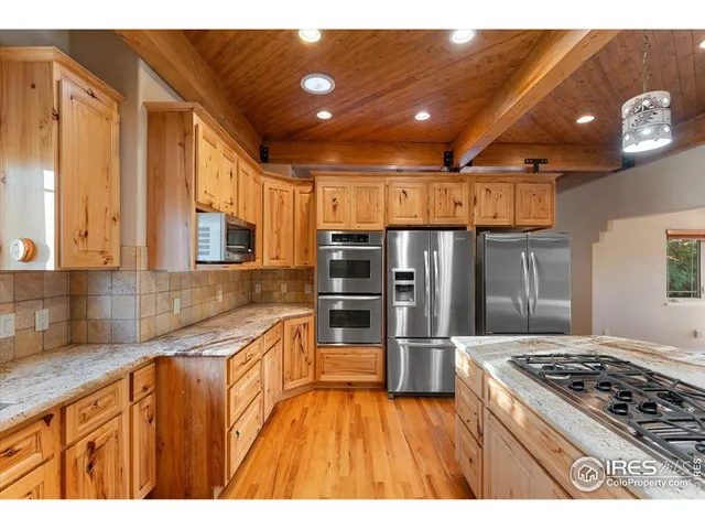 a kitchen with stainless steel appliances granite countertop a stove and a sink