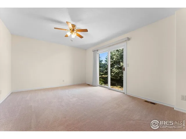 a view of a livingroom with a ceiling fan and window