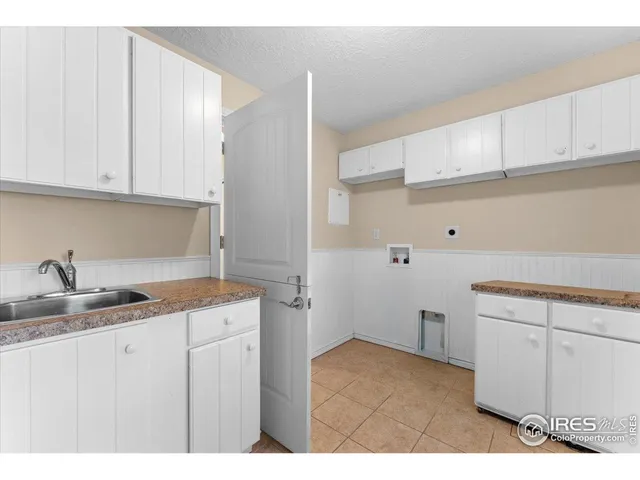 a kitchen with a sink dishwasher and cabinets