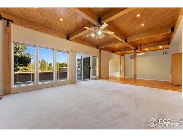 a view of a livingroom with a ceiling fan and window