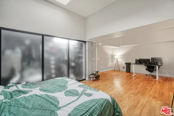 a bedroom with a bed and a mirror