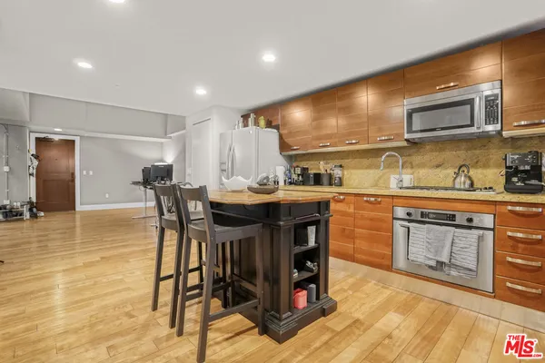 a kitchen with a table chairs sink and cabinets
