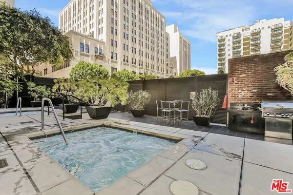 a backyard of a house with barbeque oven and outdoor seating