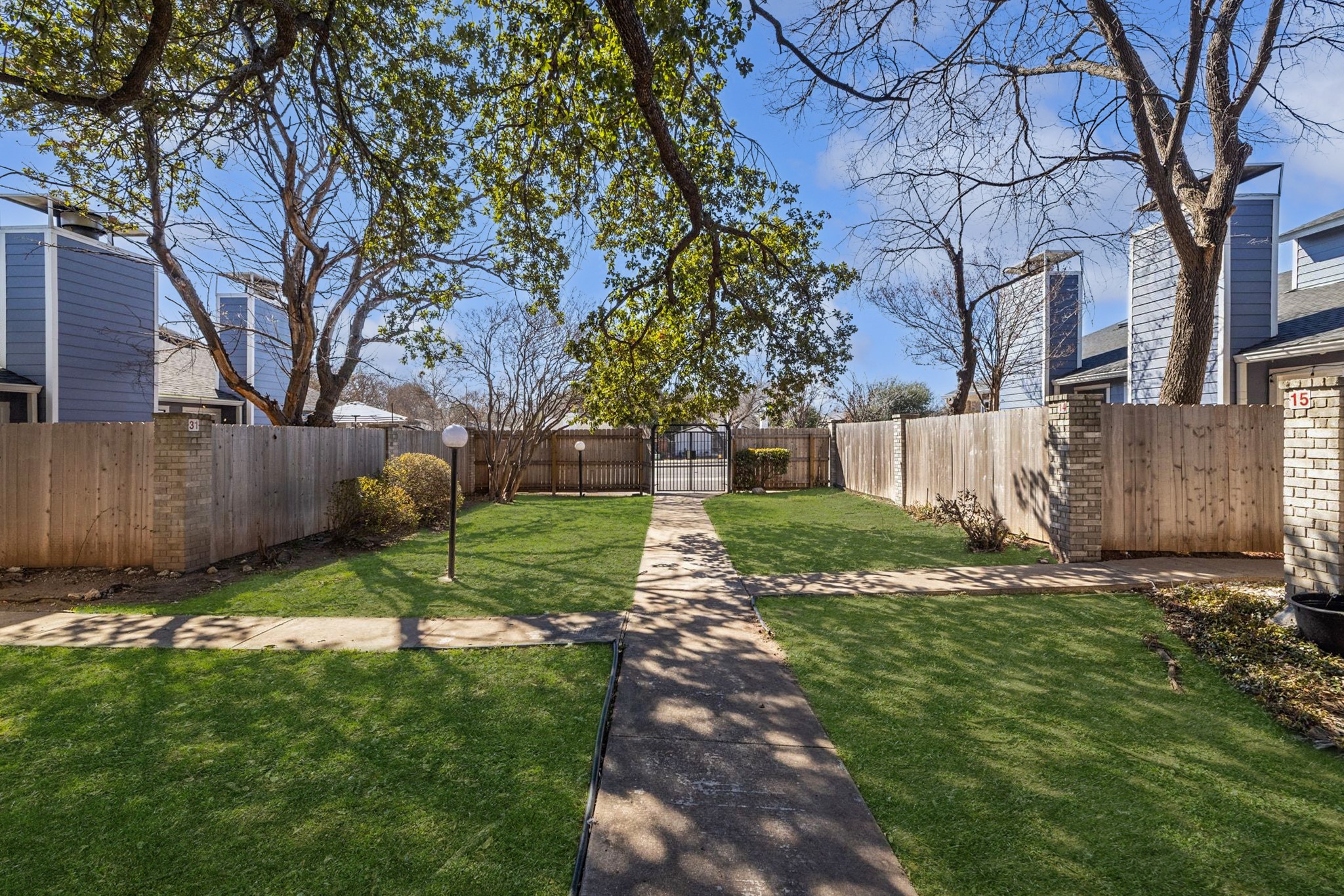 1010 West Rundberg Lane, Unit 30 Austin, TX 78758 - Photo 22 of 30 a view of backyard with table and chairs and a large tree