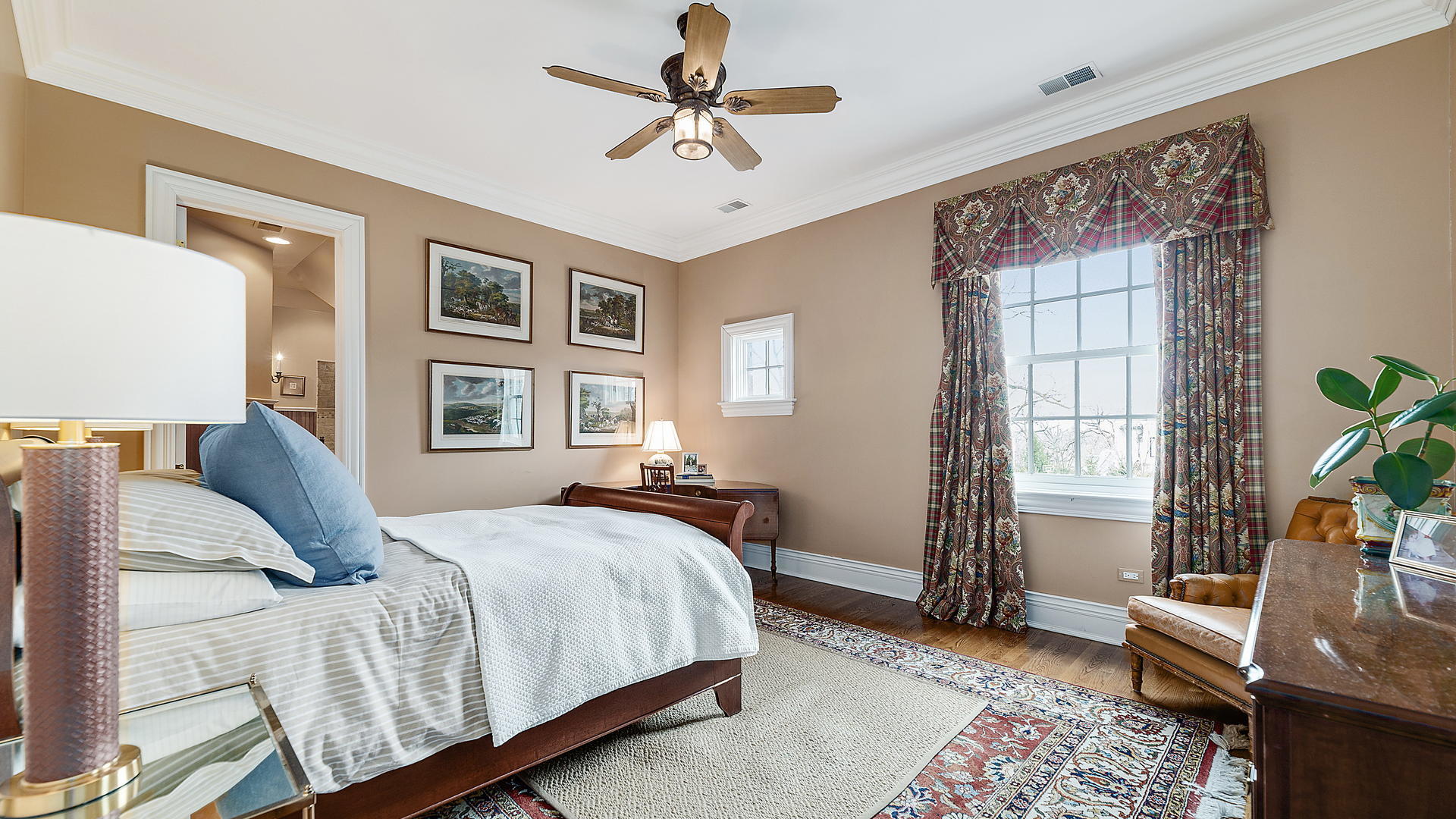 820 Taft Road Hinsdale, IL 60521 - Photo 21 of 46 a spacious bedroom with a bed a couch and a window