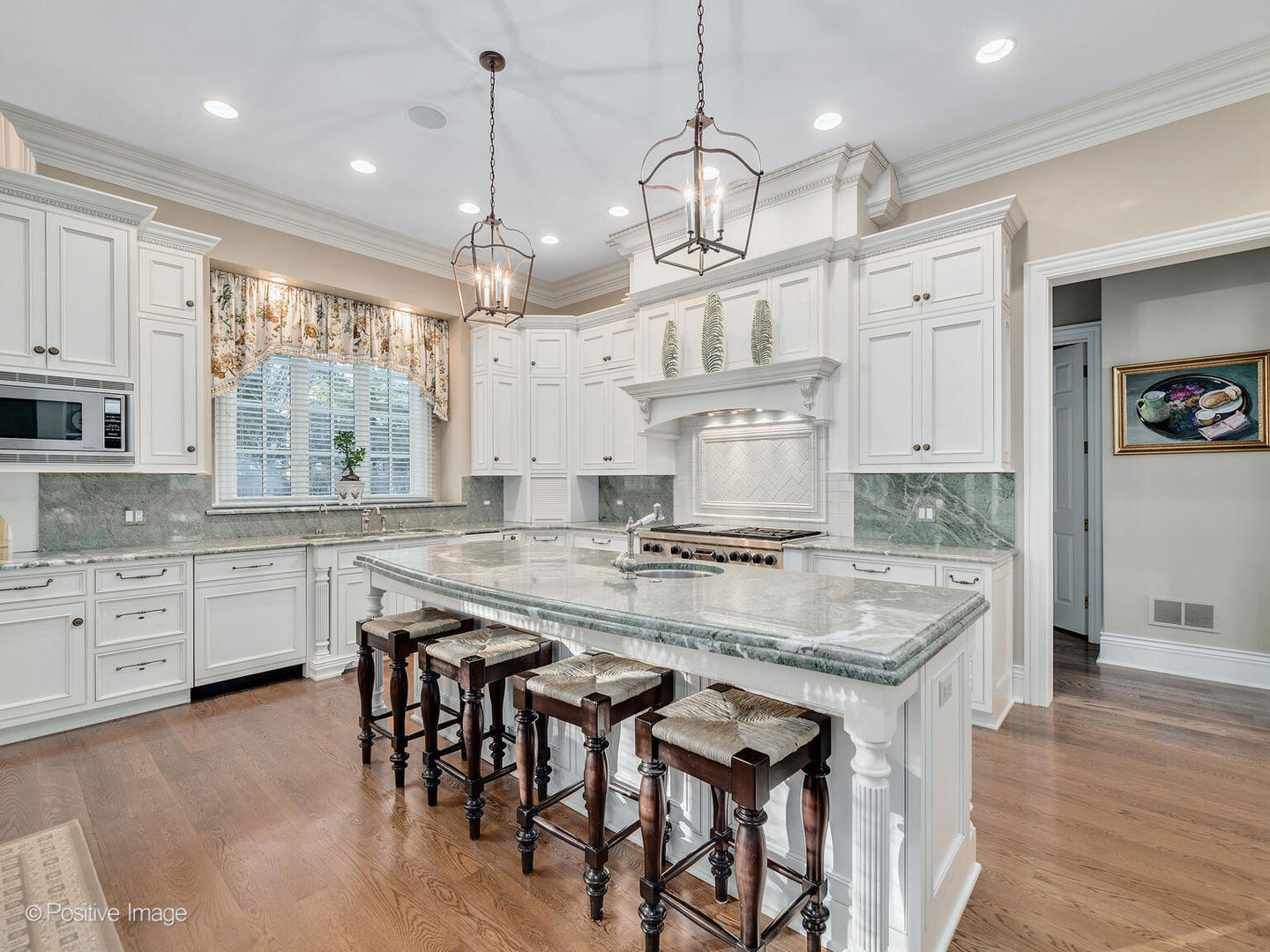 820 Taft Road Hinsdale, IL 60521 - Photo 6 of 46 a kitchen with kitchen island granite countertop a sink a center island and wooden floor