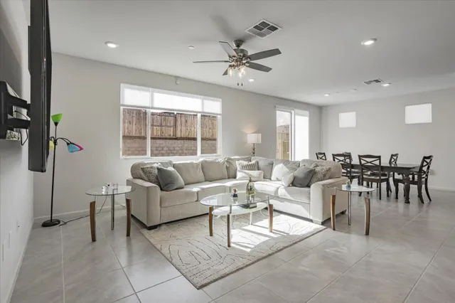 a living room with furniture and kitchen view