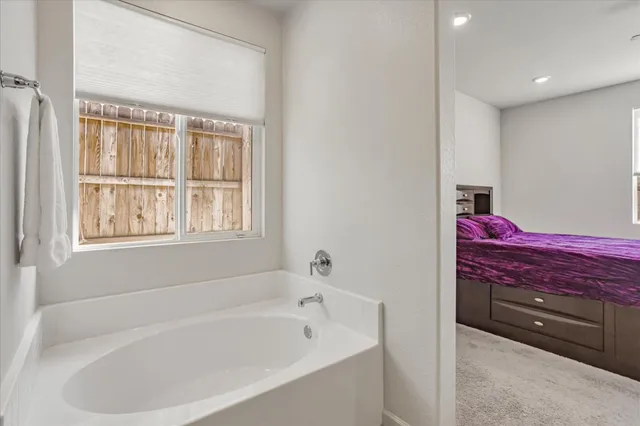 a en suite bathroom with a double vanity sink a mirror and a vanity