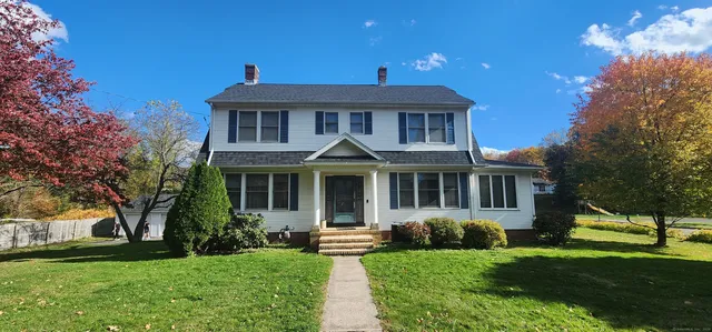 a front view of a house with a yard