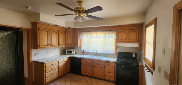 a kitchen with a refrigerator a sink and cabinets