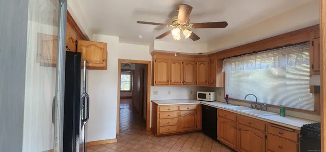 a kitchen with stainless steel appliances sink refrigerator and cabinets