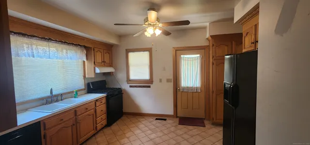 a kitchen with a refrigerator and a sink