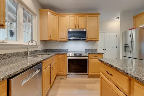 a view of an empty room with closet area