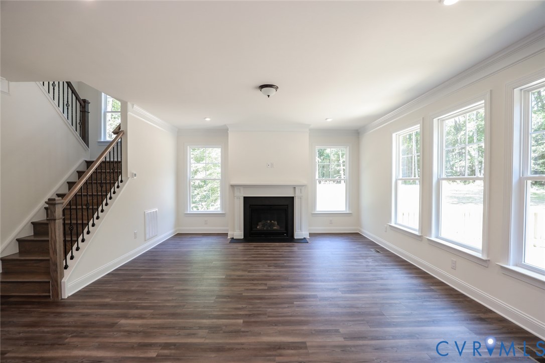4660 McGhee House Road Mechanicsville, VA 23111 - Photo 15 of 48 a view of an empty room with wooden floor fireplace and a window