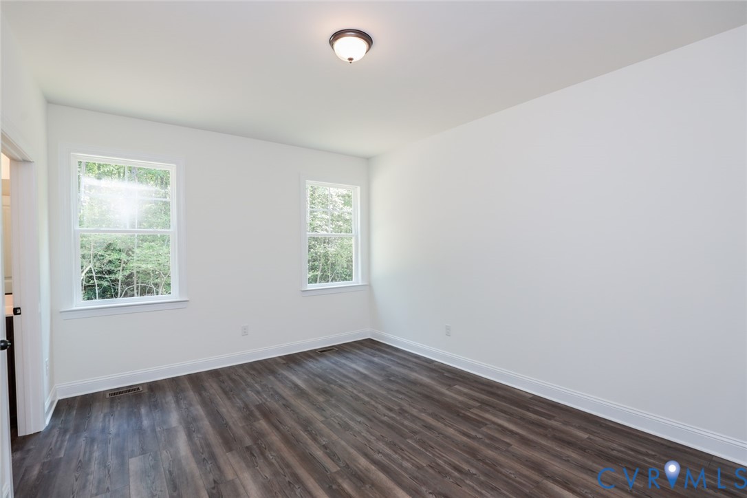 4660 McGhee House Road Mechanicsville, VA 23111 - Photo 16 of 48 an empty room with wooden floor and windows