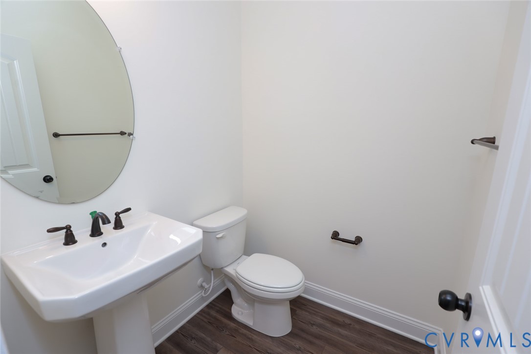 4660 McGhee House Road Mechanicsville, VA 23111 - Photo 18 of 48 a white toilet sitting next to a bathroom sink