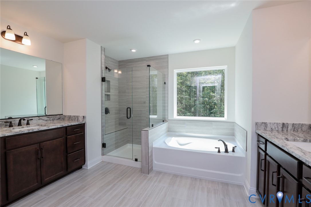 4660 McGhee House Road Mechanicsville, VA 23111 - Photo 25 of 48 a bathroom with a granite countertop tub sink shower and mirror