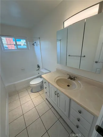 a bathroom with a sink a toilet a mirror and vanity
