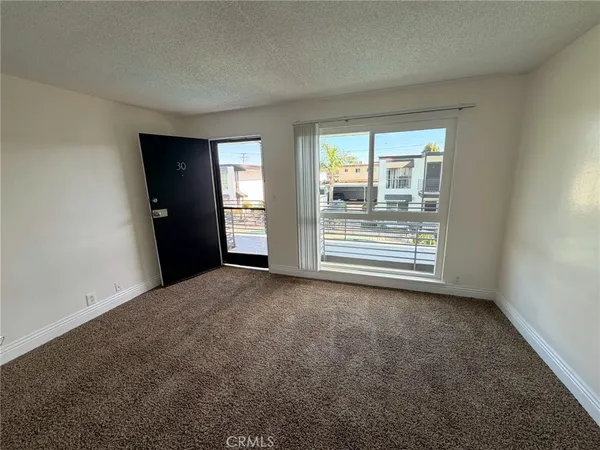 a view of a balcony with floor to ceiling windows with wooden floor