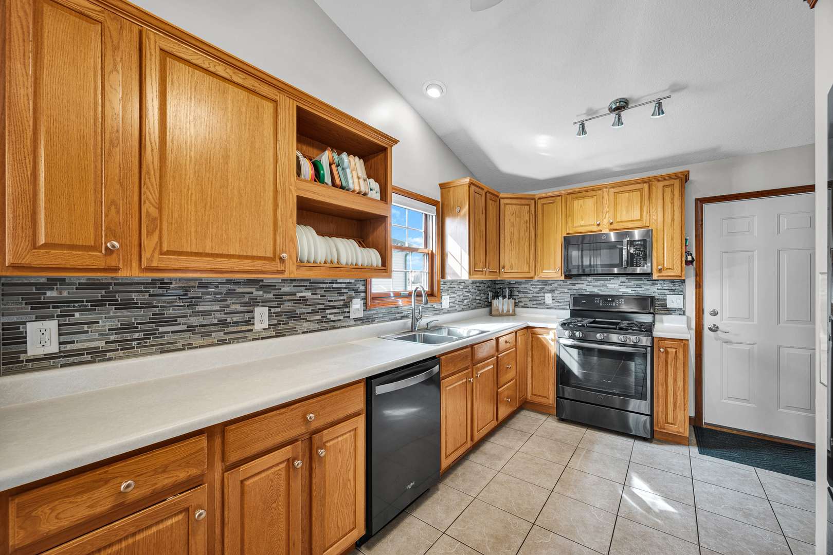 1829 Derek Drive Normal, IL 61761 - Photo 11 of 37 a kitchen with stainless steel appliances granite countertop a sink stove and refrigerator