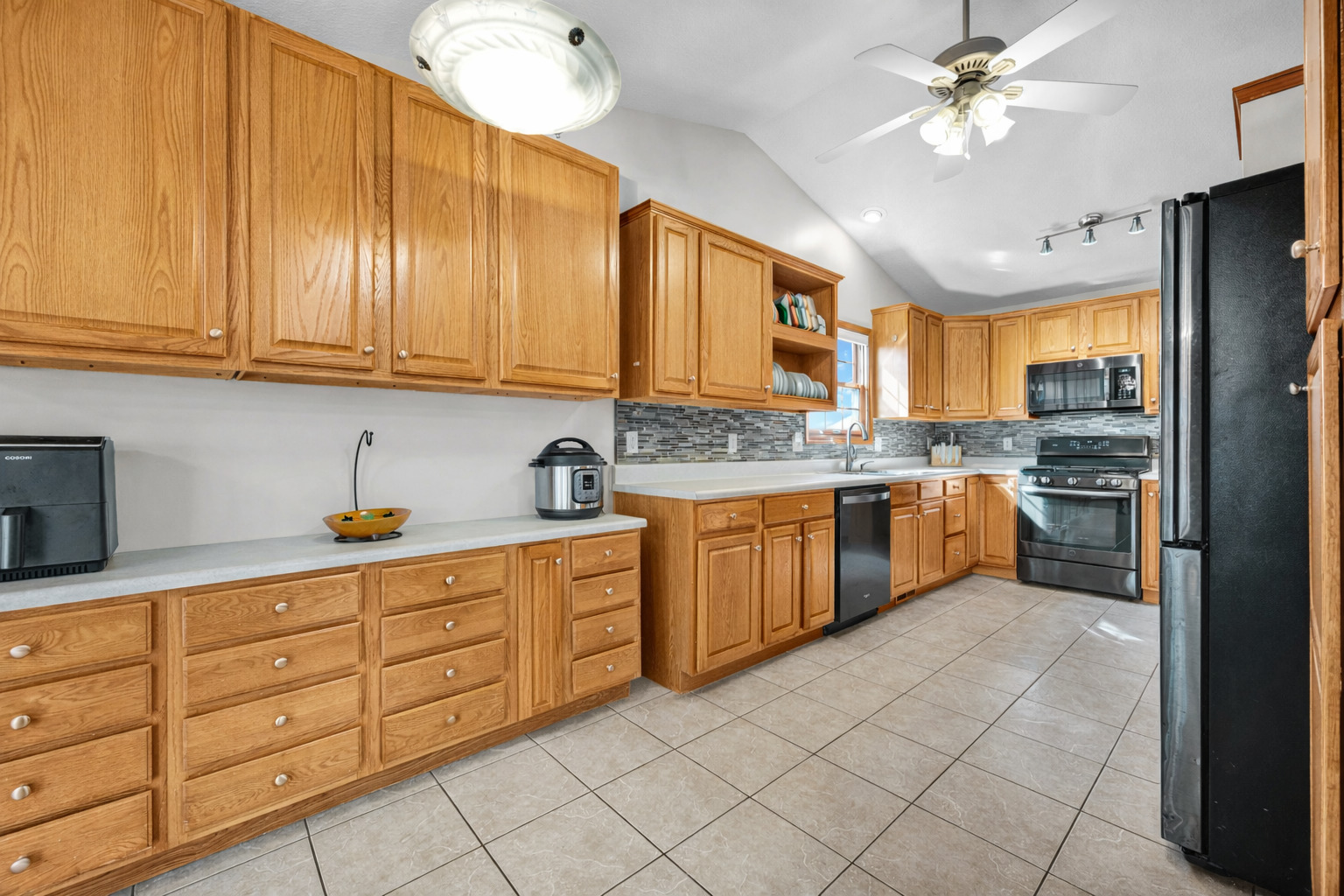 1829 Derek Drive Normal, IL 61761 - Photo 12 of 37 a kitchen with stainless steel appliances granite countertop a stove sink and cabinets