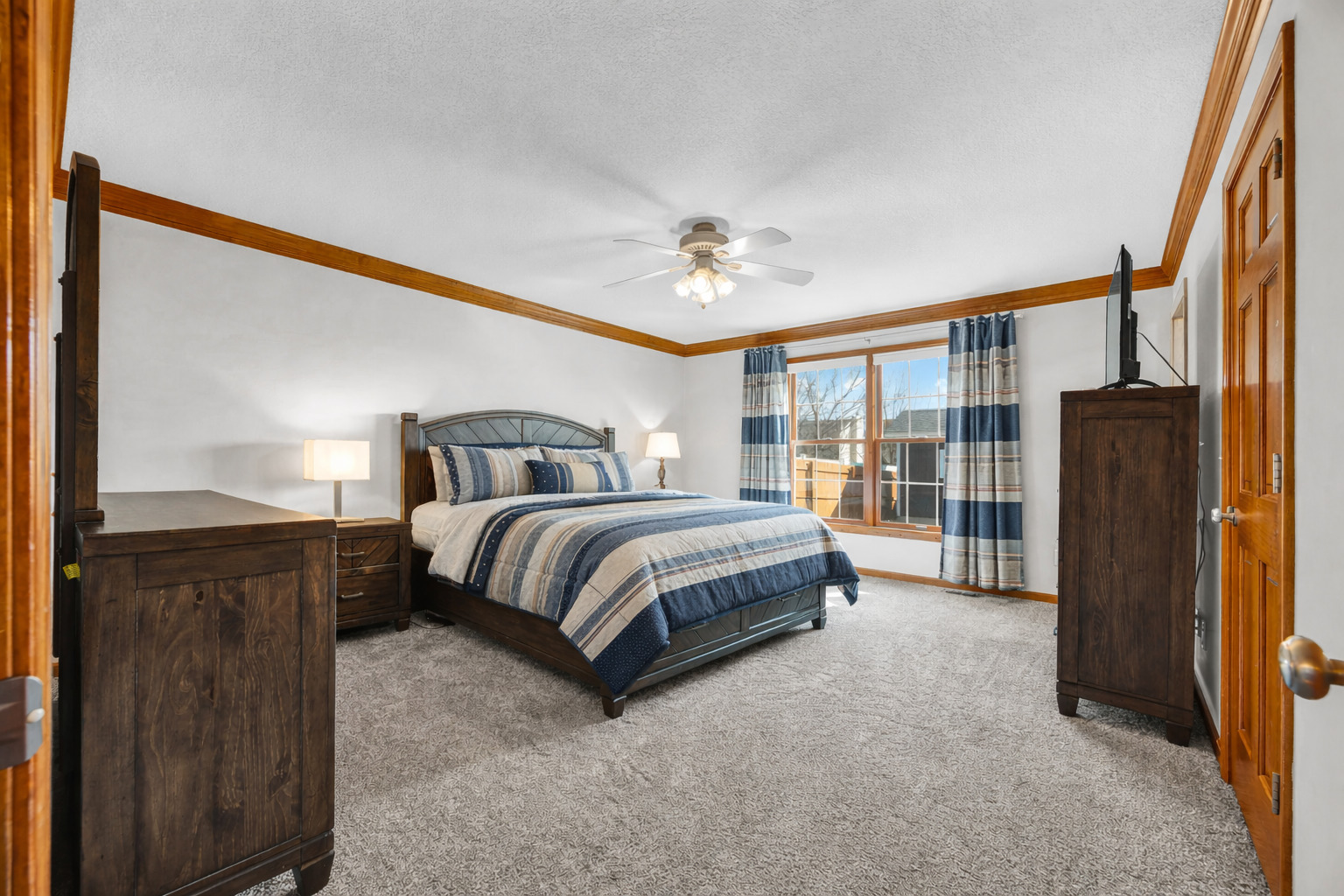 1829 Derek Drive Normal, IL 61761 - Photo 18 of 37 a spacious bedroom with a bed table and a walk in closet