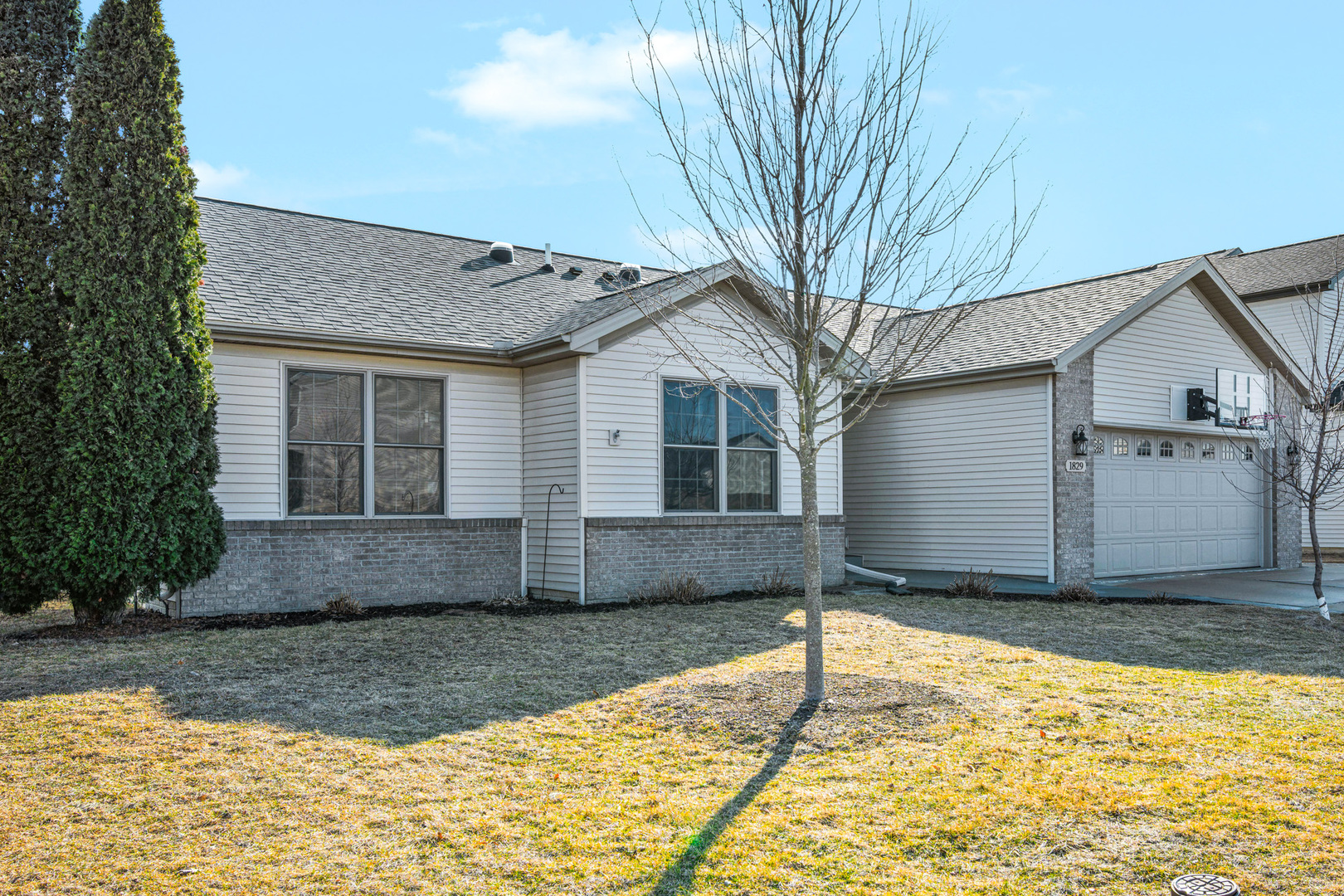 1829 Derek Drive Normal, IL 61761 - Photo 2 of 37 a front view of a house with a yard and garage
