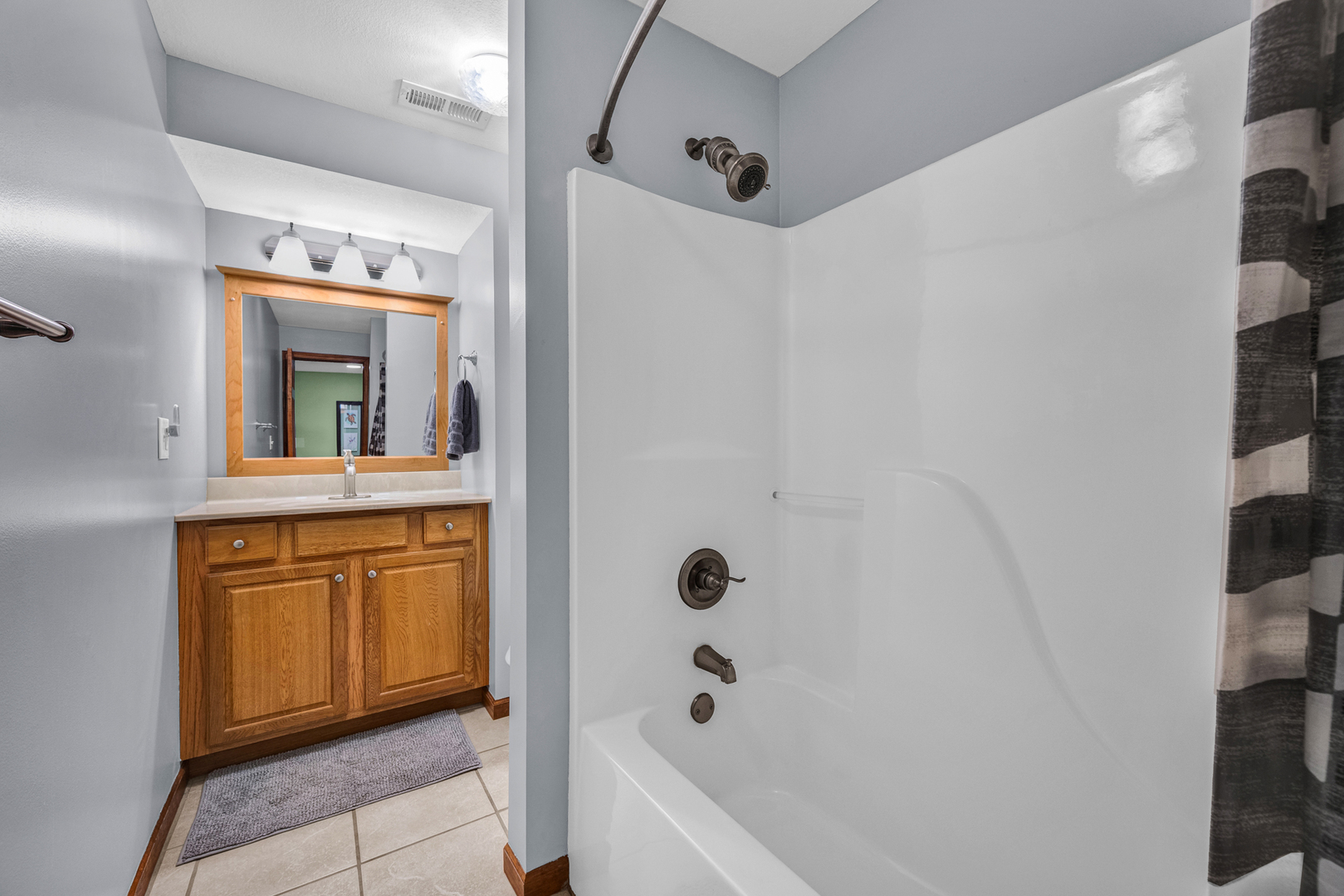 1829 Derek Drive Normal, IL 61761 - Photo 29 of 37 a bathroom with a sink a mirror and a bathtub