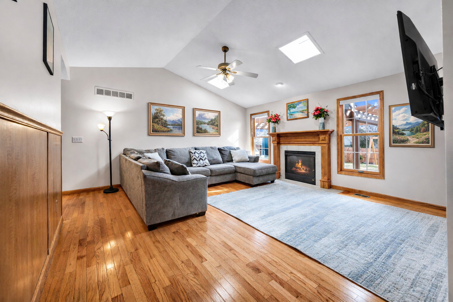 1829 Derek Drive Normal, IL 61761 - Photo 7 of 37 a living room with furniture a flat screen tv and a fireplace