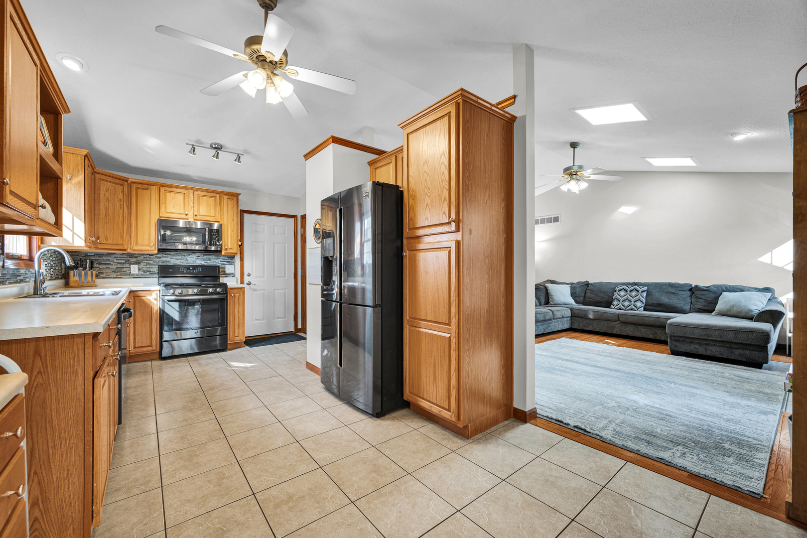 1829 Derek Drive Normal, IL 61761 - Photo 10 of 37 a kitchen with stainless steel appliances kitchen island granite countertop a refrigerator a stove and a sink