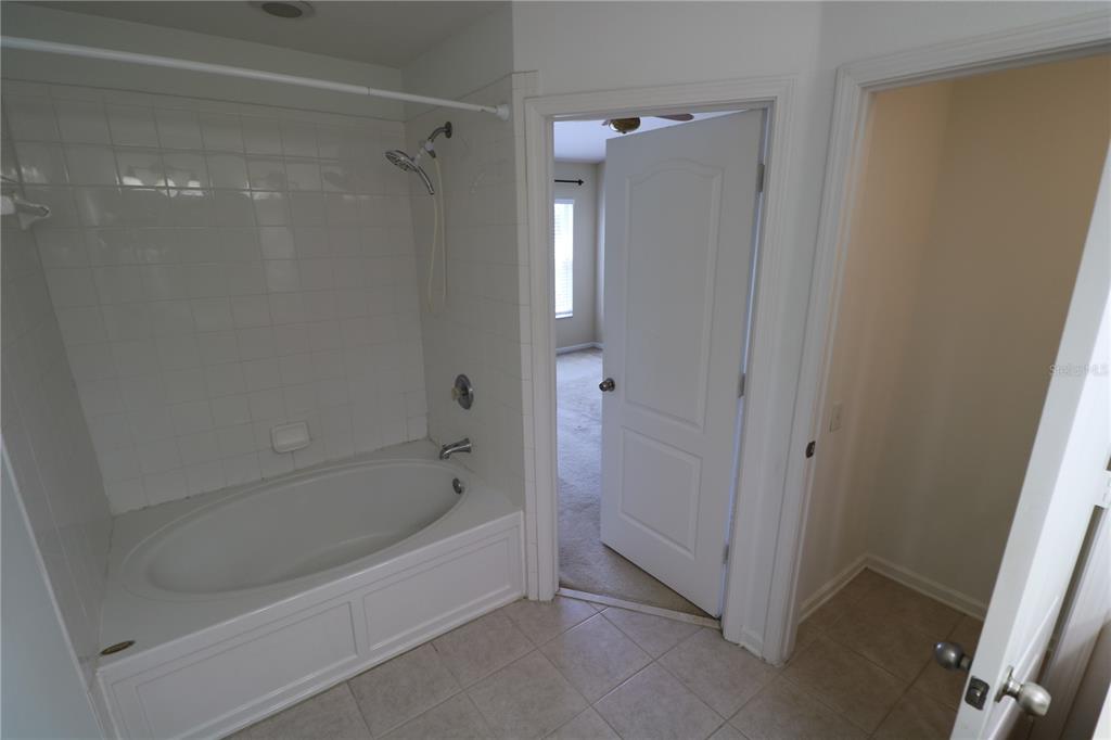 4866 Pond Ridge Drive Riverview, FL 33578 - Photo 29 of 38 a bathroom with a bathtub and a shower