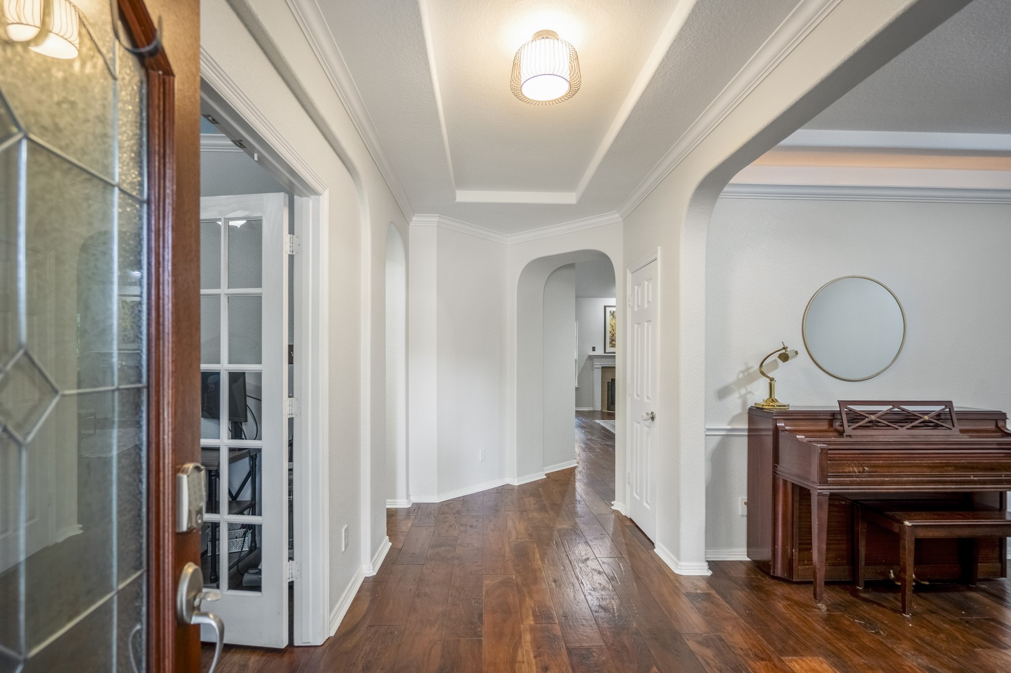 10410 Pitcataway Drive Spring, TX 77379 - Photo 4 of 48 As you enter the home you are greeted by gleaming hand scaped wood flooring, arched doorways and trey style ceiling and neutral tones.