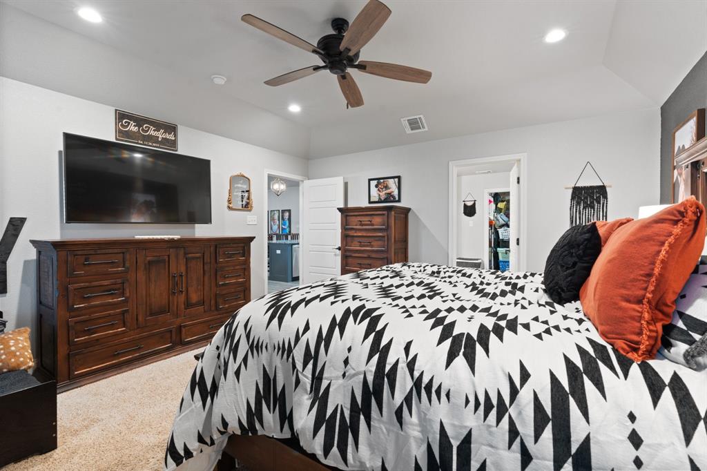 121 Treys Way Godley, TX 76044 - Photo 14 of 32 a bedroom with a bed and a flat screen television