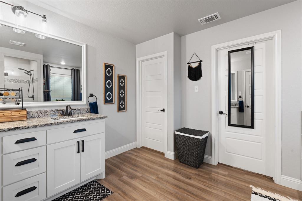 121 Treys Way Godley, TX 76044 - Photo 16 of 32 a bathroom with a sink and a mirror