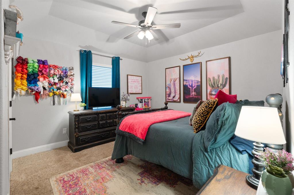 121 Treys Way Godley, TX 76044 - Photo 21 of 32 a bedroom with a bed dresser and window
