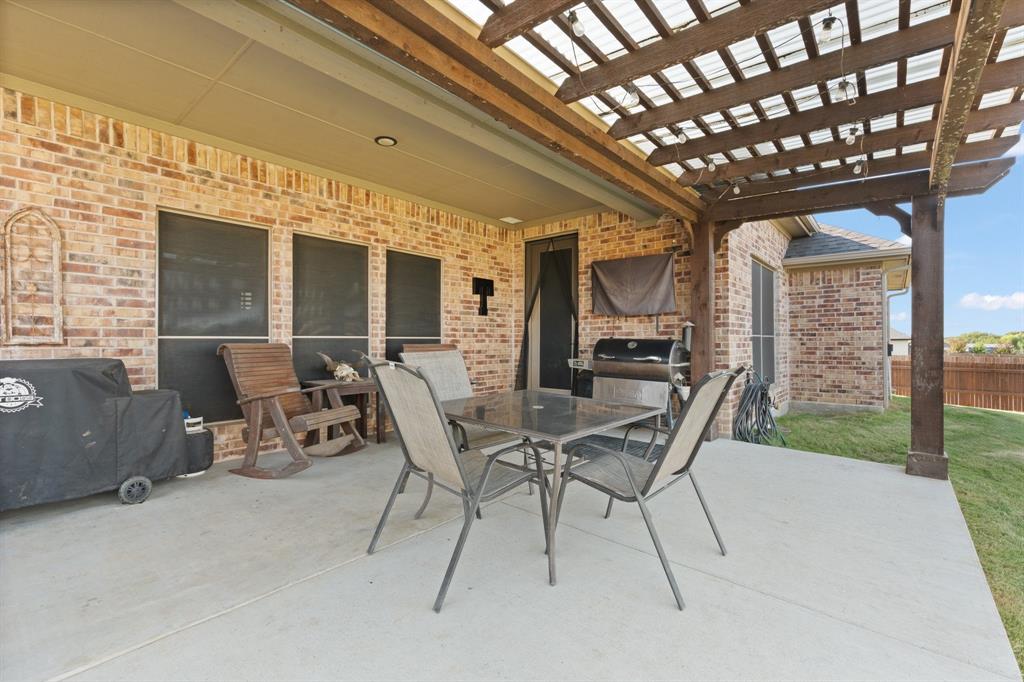 121 Treys Way Godley, TX 76044 - Photo 26 of 32 a view of a patio with table and chairs