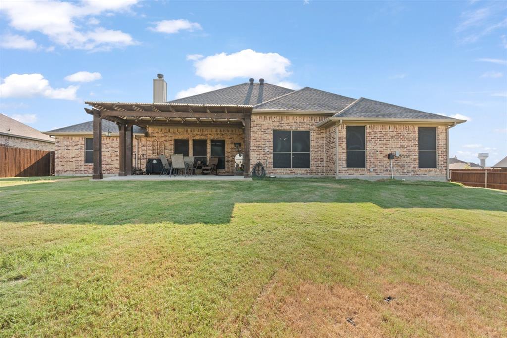 121 Treys Way Godley, TX 76044 - Photo 28 of 32 a front view of a house with a yard