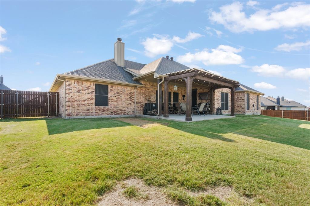 121 Treys Way Godley, TX 76044 - Photo 29 of 32 a front view of a house with a garden