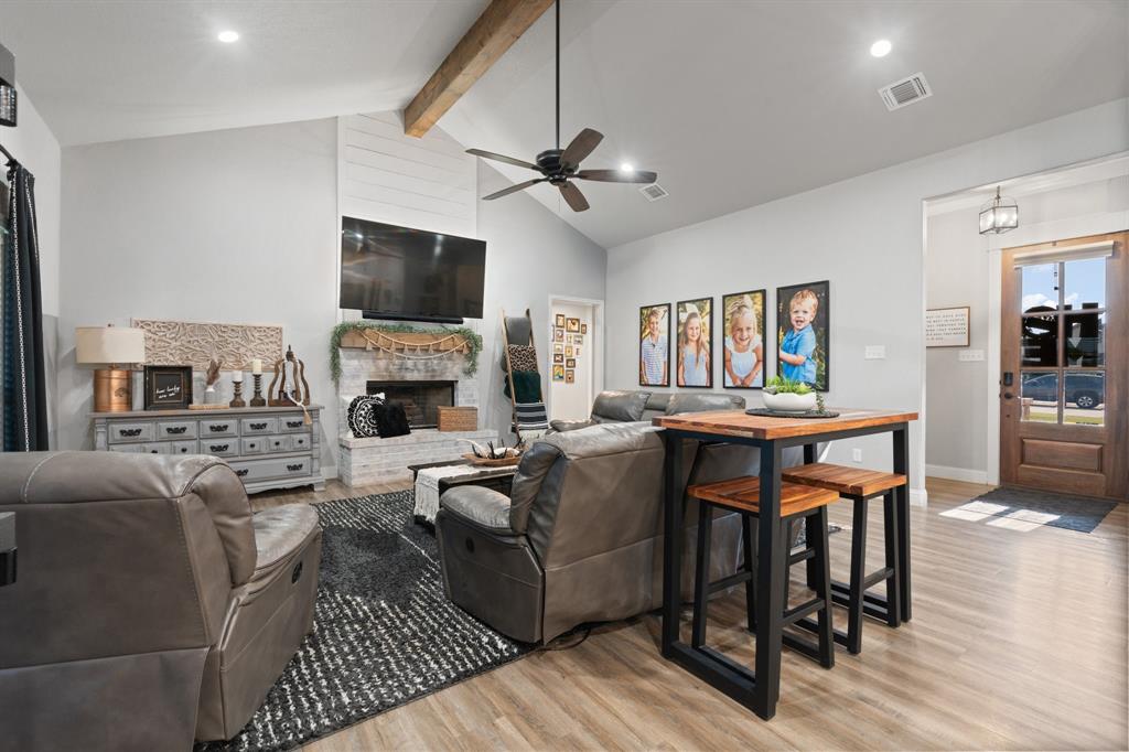 121 Treys Way Godley, TX 76044 - Photo 7 of 32 a living room with fireplace furniture and a flat screen tv