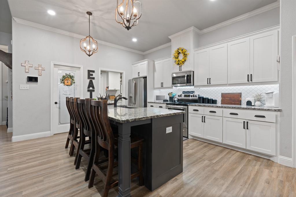 121 Treys Way Godley, TX 76044 - Photo 8 of 32 a kitchen with a refrigerator and microwave