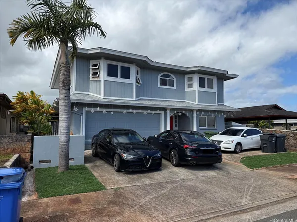 a couple of cars parked in front of a house