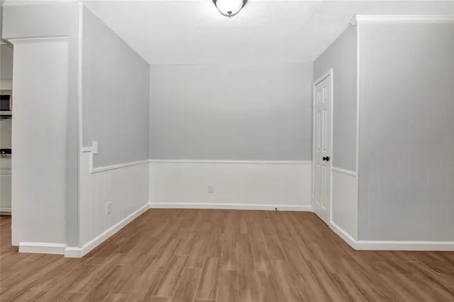 a view of a room with wooden floor
