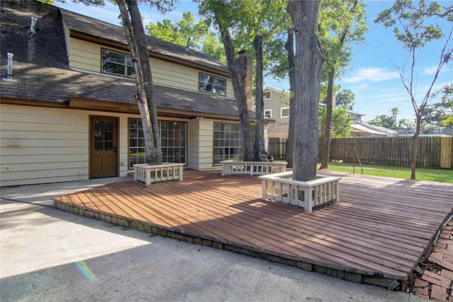 a wooden bench sitting in front of a house