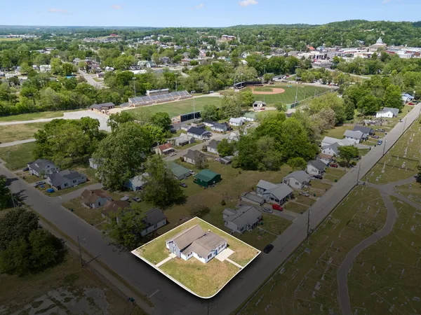 an aerial view of a residential houses with outdoor space and river