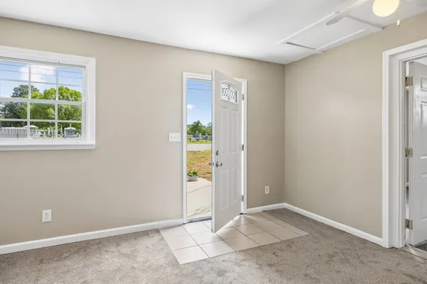 an empty room with windows and closet