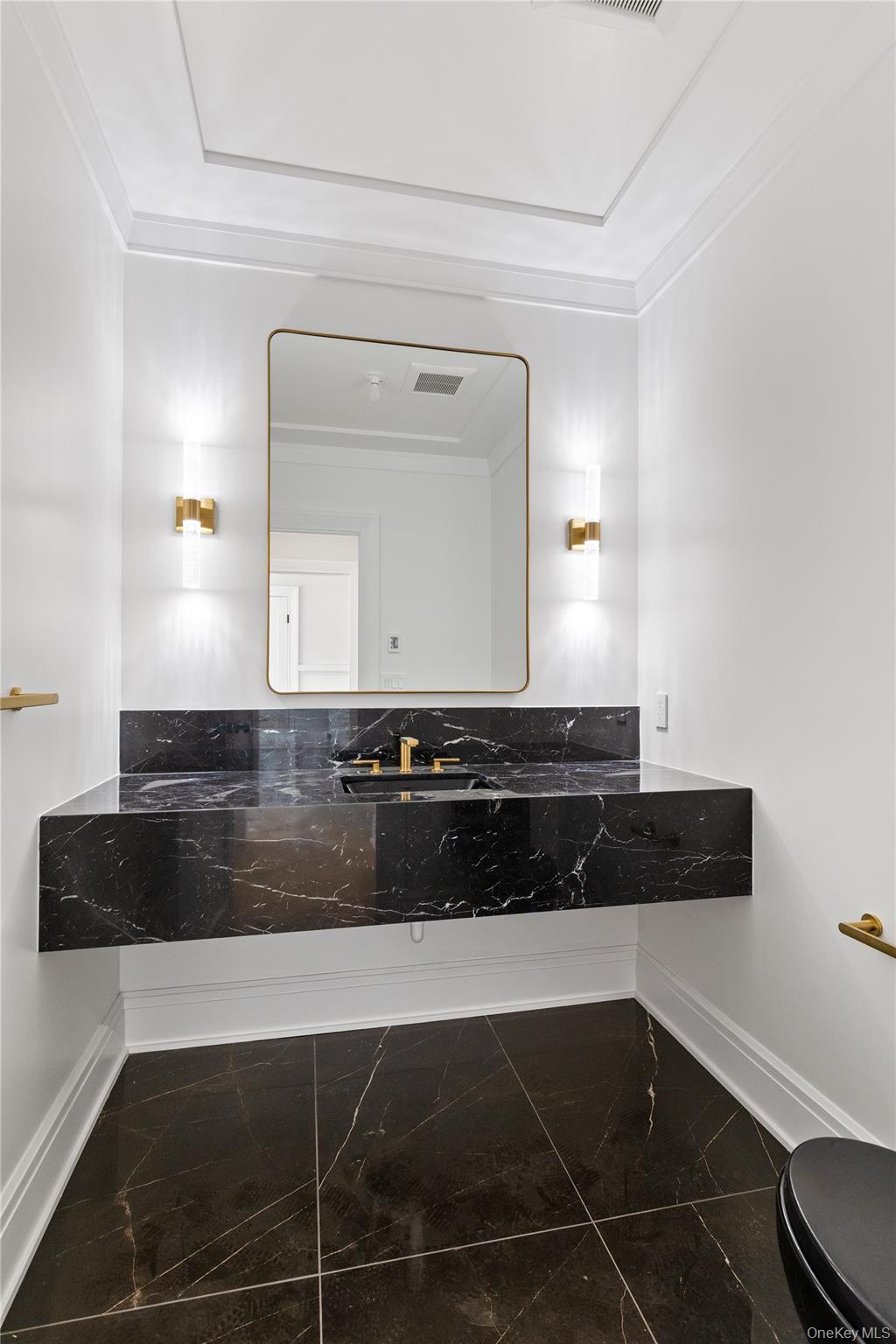 42 Mamaroneck Road Scarsdale, NY 10583 - Photo 12 of 47 The elegant powder room showcases contemporary finishes and refined designer details for guests.