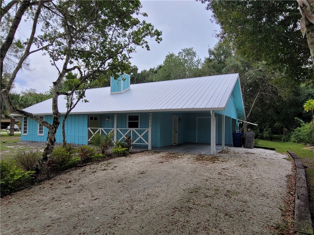 a view of a house with a yard and tree