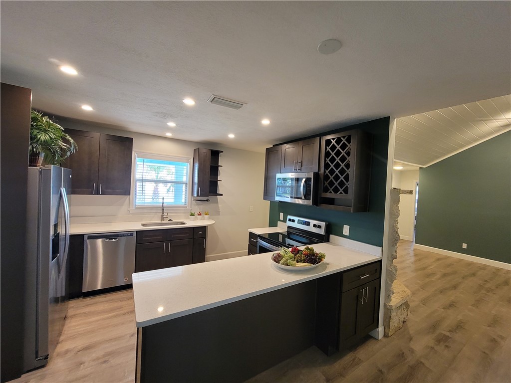 6515 5th Street Vero Beach, FL 32968 - Photo 11 of 36 a kitchen with a sink stove and refrigerator
