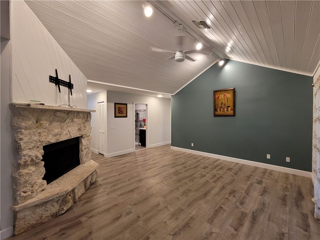 6515 5th Street Vero Beach, FL 32968 - Photo 14 of 36 a view of empty room with wooden floor and fireplace